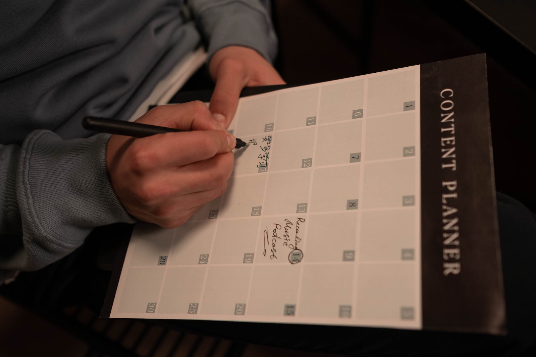 a hand writing on a planner